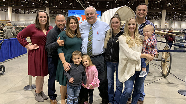 Dr. Scott Williamson stands in the middle, flanked by his family.