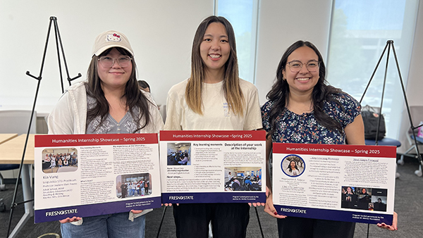 Three students showcasing there internship highlights at event.