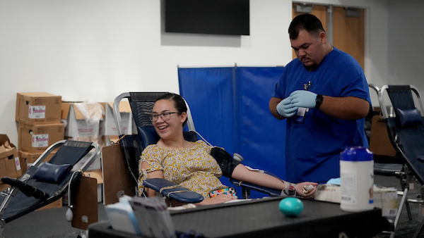 Women is getting blood drawn for blood drive.