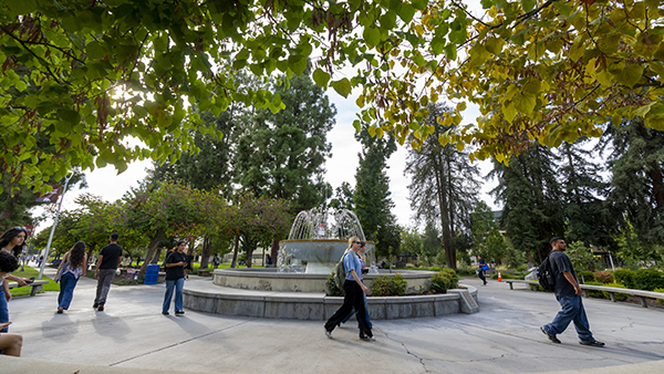Students walking in front of the fountain at Fresno State.