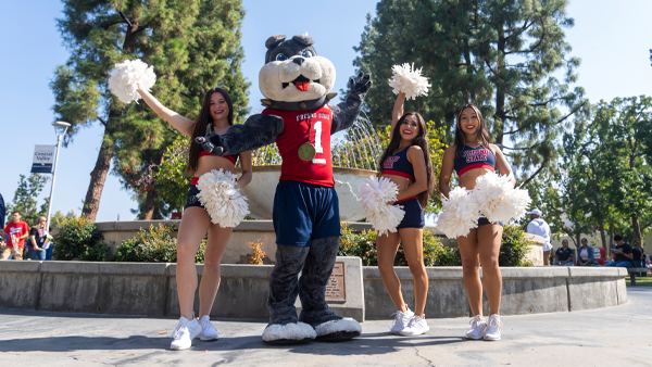 TimeOut poses with three Fresno State cheerleaders in front of the fountain.