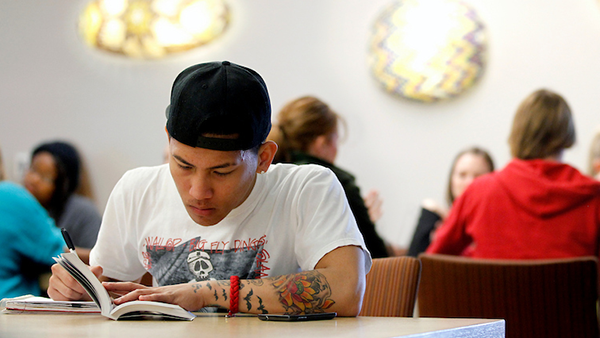 A student, studying with a book